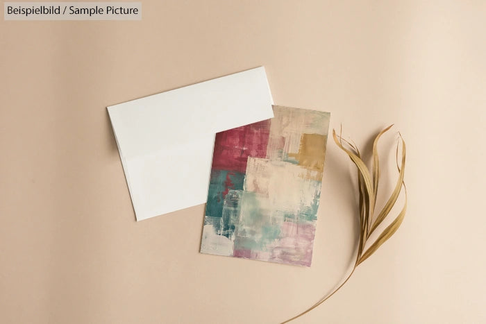 Abstract greeting card with pastel colors and dried leaves on a beige background.