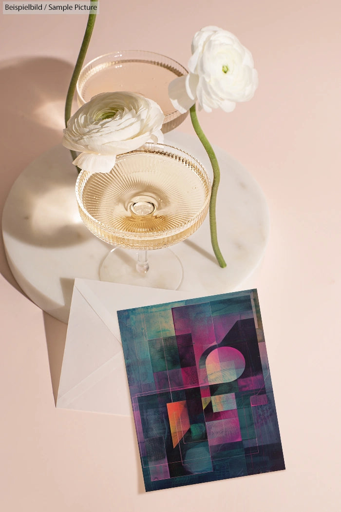 Two champagne glasses on a marble tray with white flowers and an abstract art card on a beige background.