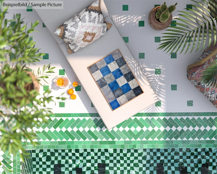 Top view of a tiled pool area with a lounge chair, checkerboard, and tropical plants under sunlight.