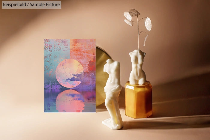 Abstract artwork with circle design next to white statues on a beige background.