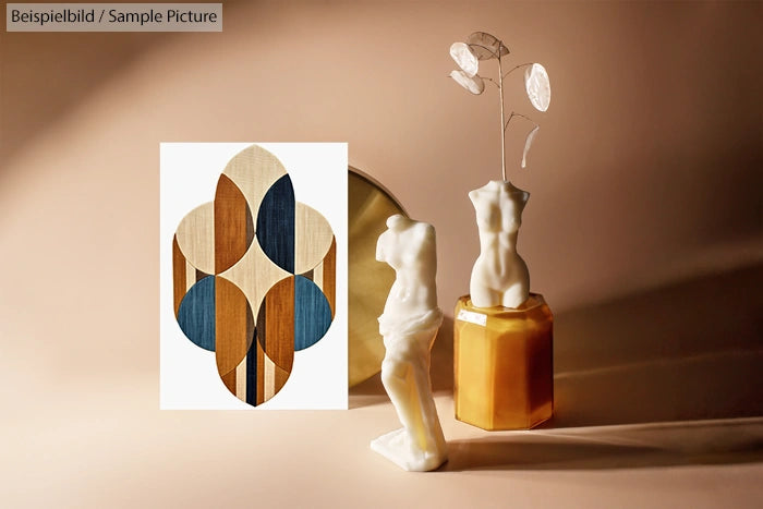 Artistic display with abstract geometric artwork and classical sculpture busts on a warm-toned background.