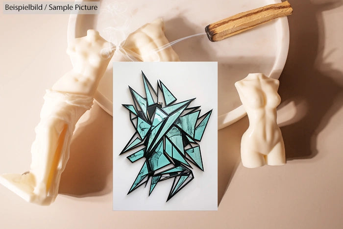 Abstract artwork with geometric shapes and turquoise fragments, surrounded by mannequin torsos and a croissant-like pastry.