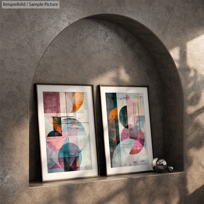 Two abstract paintings with geometric shapes in vibrant colors displayed in an alcove with shadows on a textured wall.