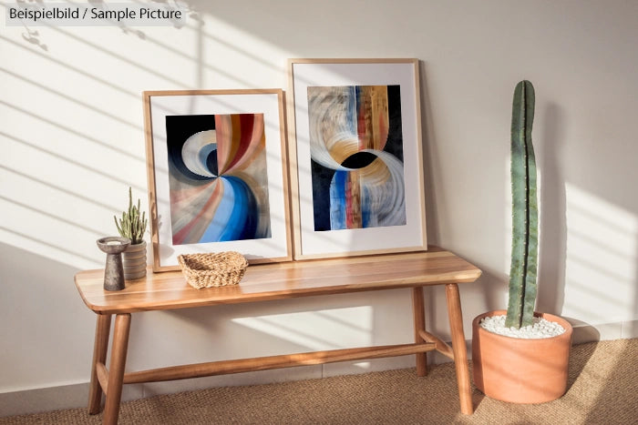 Minimalist room with abstract art, cacti, and wooden bench under soft sunlight.