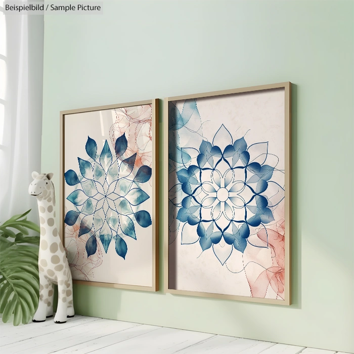 Two framed abstract floral artworks with blue and red tones on a wall, next to a polka-dot giraffe sculpture.