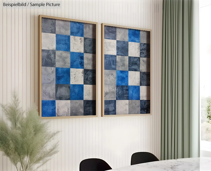 Two framed abstract paintings with blue and gray checkered patterns on a white wall.