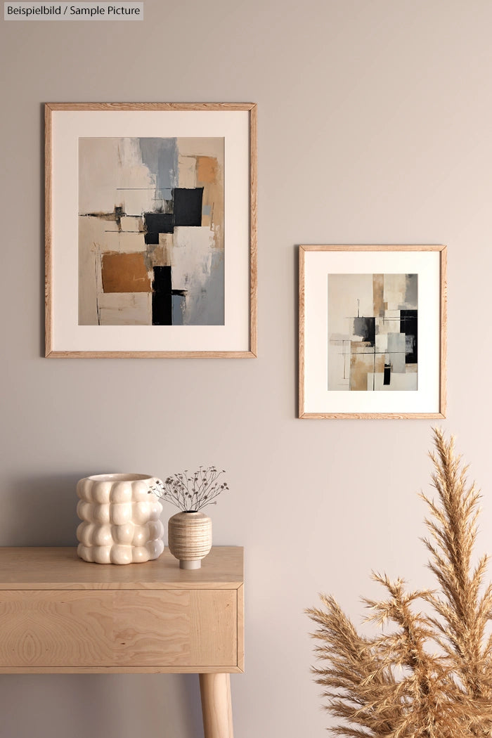 Modern living room with abstract paintings, a wooden console, and decorative vases and dried plants.