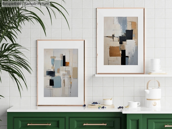 Kitchen wall with abstract paintings, green cabinets, and modern decor elements, including plants and tableware.