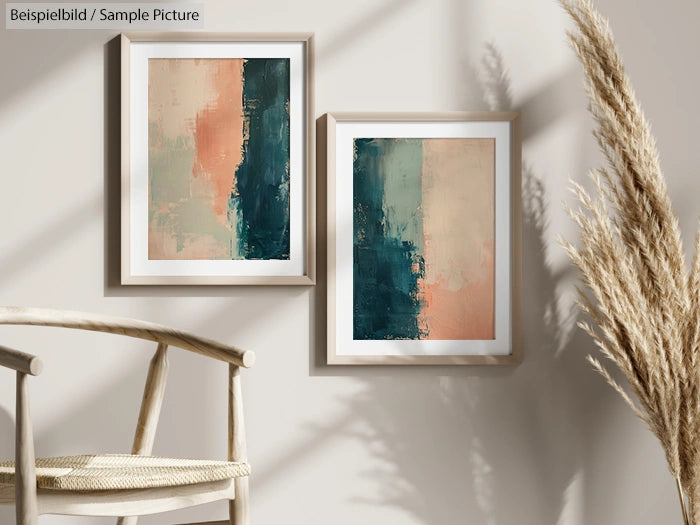 Two abstract paintings with blue and beige tones in frames, displayed on a wall next to pampas grass in a minimalist room.