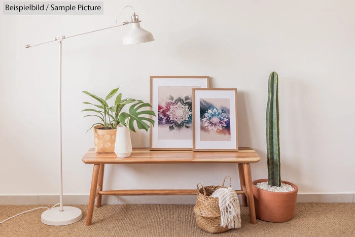 Minimalist interior with a bench, two framed artworks, plants, a floor lamp, and a woven basket.