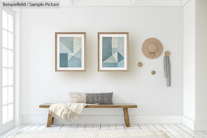 Scandinavian-style living room with a wooden bench, abstract paintings, a straw hat, and neutral decor.