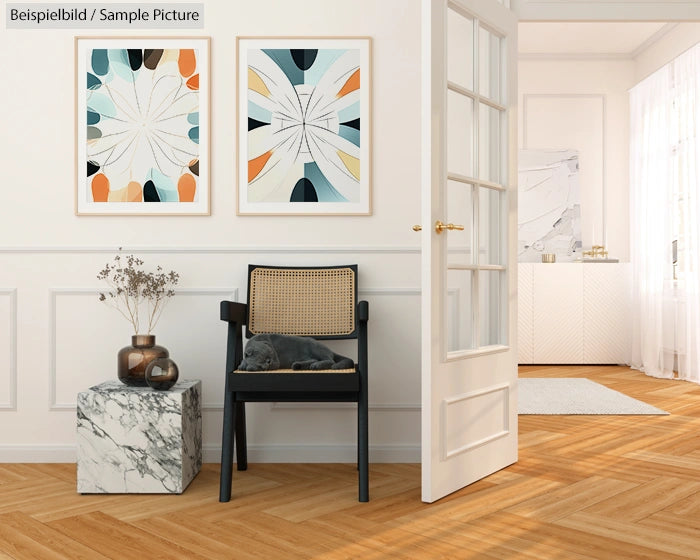 Modern interior with abstract artwork, a chair with a cushion, and a marble side table with a plant on wooden flooring.