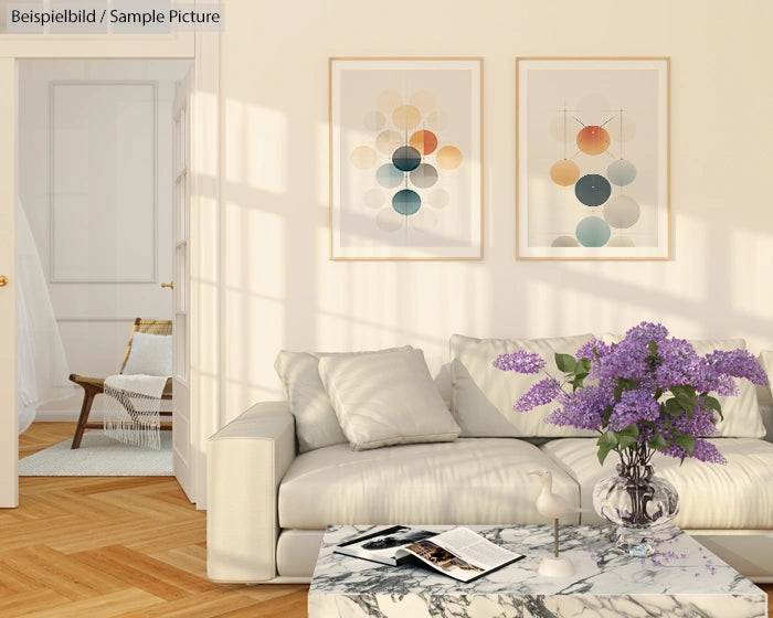 Modern living room with white sofa, marble table, lavender flowers, and abstract art on wall.