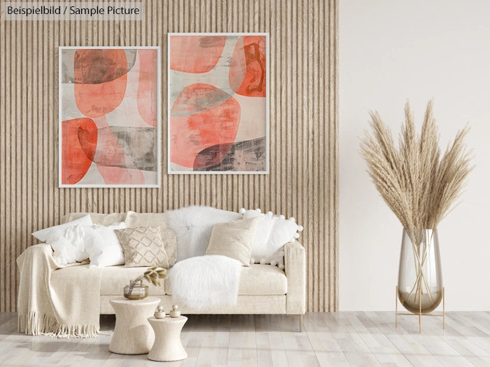 Modern living room with abstract red artwork, beige sofa, textured wall, and pampas grass in a glass vase.