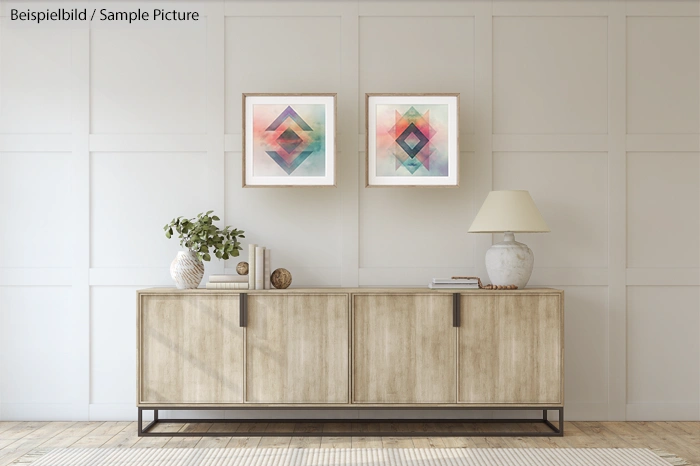 Modern living room with wooden sideboard, geometric art on wall, potted plant, table lamp, and decor objects.