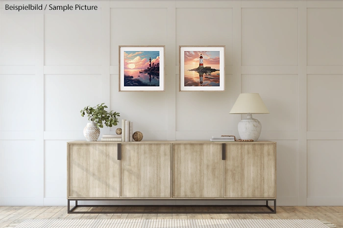 Minimalist living room with light wood sideboard, art frames on wall, vase with foliage, lamp, and decorative objects.