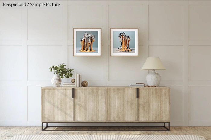 Minimalist living room with wooden cabinet, lamp, plant, and two abstract paintings on a paneled wall.