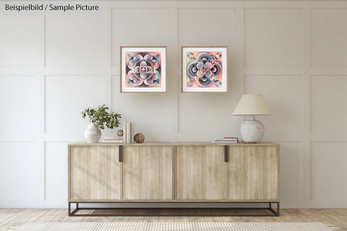 Modern living room with wooden sideboard, two abstract art pieces, a lamp, and a plant against a paneled wall.