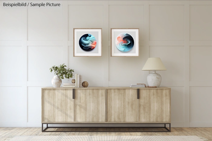 Modern living room with two abstract paintings above a beige cabinet, adorned with a lamp and decorative vases.