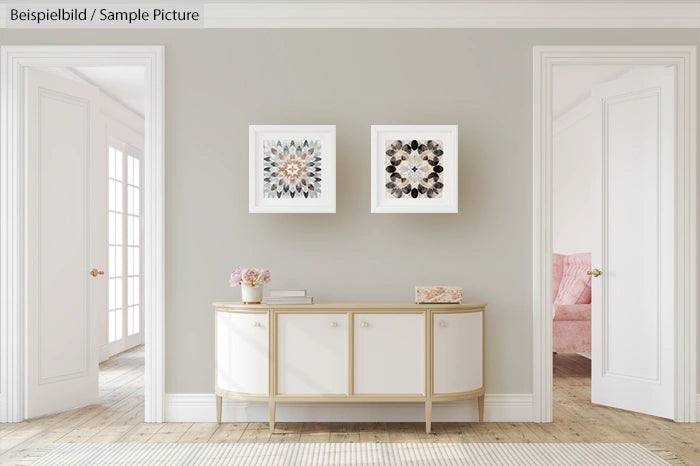 Elegant living room with modern beige sideboard, two framed artworks, and pink chair visible through doorway.