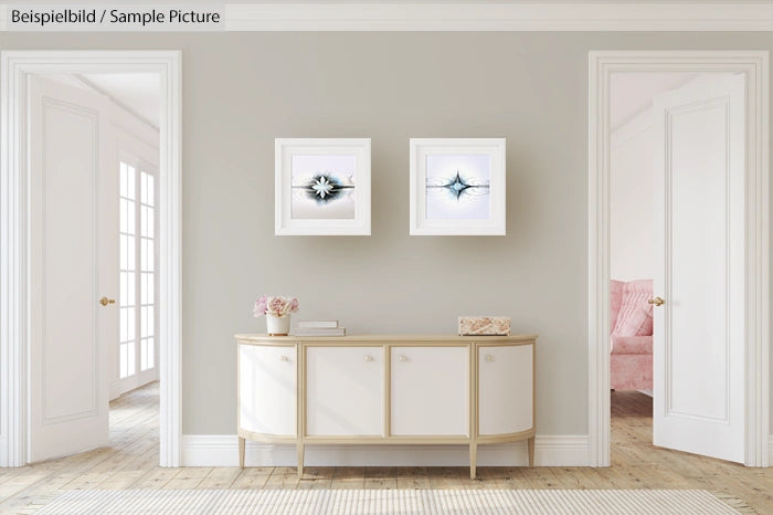 Minimalist living room with modern sideboard and abstract art on walls.