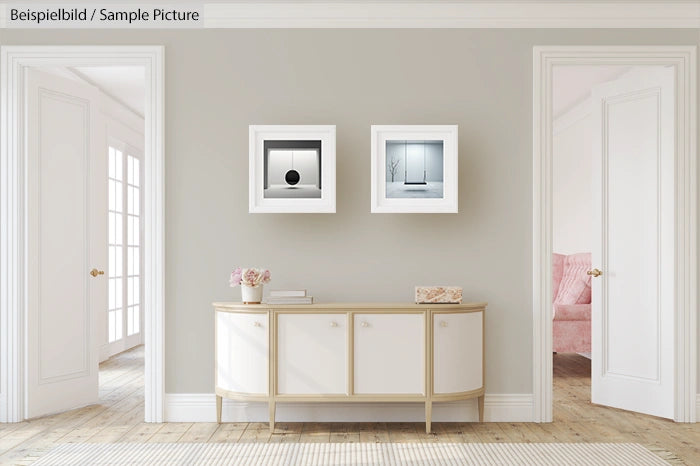 Modern living room with a sideboard and framed abstract art on light gray walls.