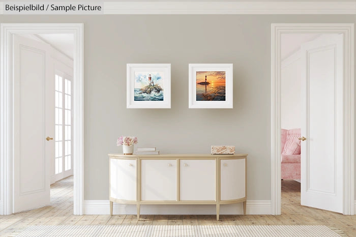 Elegant living room with two framed ocean art pieces above a modern white console table.