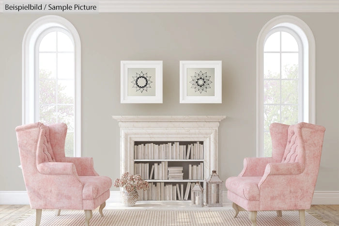 Elegant living room with pink armchairs, white fireplace, bookshelves, and framed geometric art on gray walls.