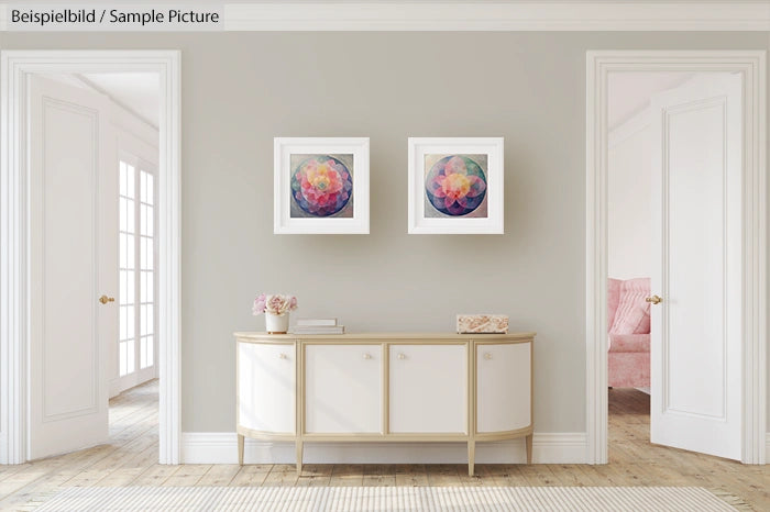 Minimalist hallway with white sideboard, two abstract paintings, and soft lighting.