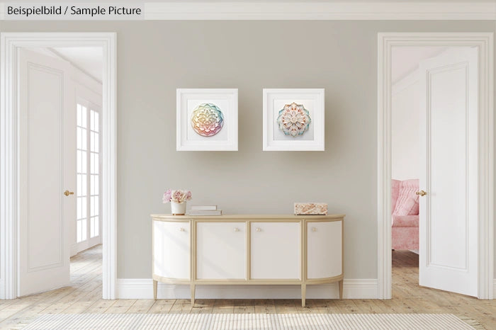 Modern living room with white console, decorative art on wall, elegant decor in neutral tones, and pink accents.