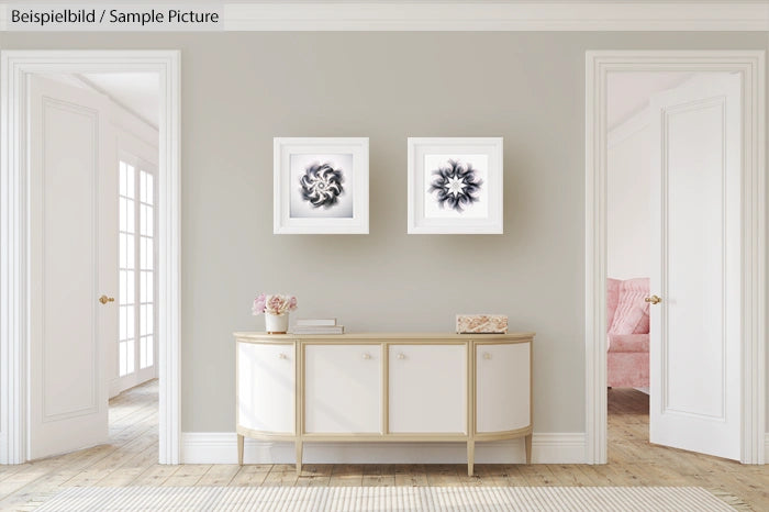 Modern hallway with two abstract framed artworks above a sleek sideboard and doorways to adjoining rooms.