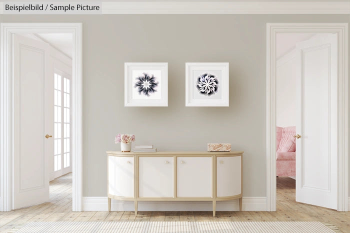 Modern living room with light gray walls, two abstract paintings, and a white sideboard with decor accents.