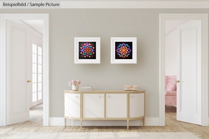 Stylish living room with modern sideboard, two geometric artworks, and a glimpse of a cozy room with a pink chair.