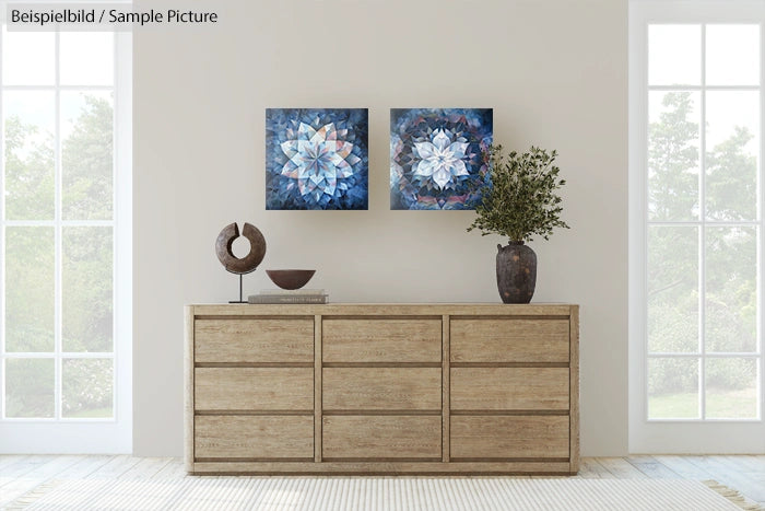 Modern living room with wooden dresser, decorative vase, and abstract paintings on a beige wall.