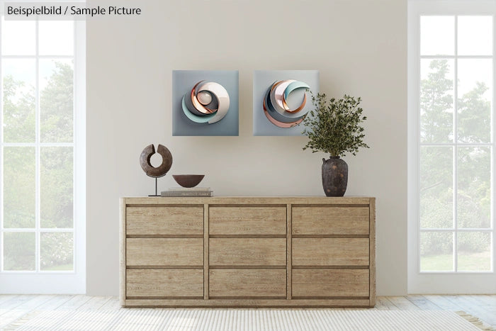 Modern minimalist living room with wooden dresser, abstract wall art, and potted plant.