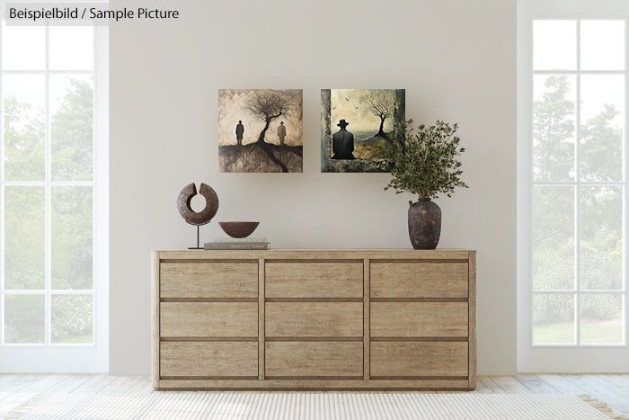 Minimalist room with wooden sideboard, abstract tree paintings on wall, and large vase with leafy plant.