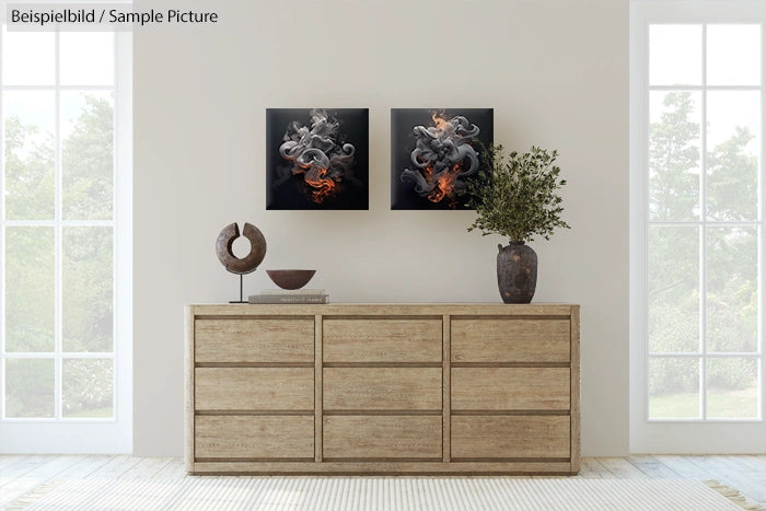 Minimalist room with wooden dresser, art pieces on wall, and vase with plant.