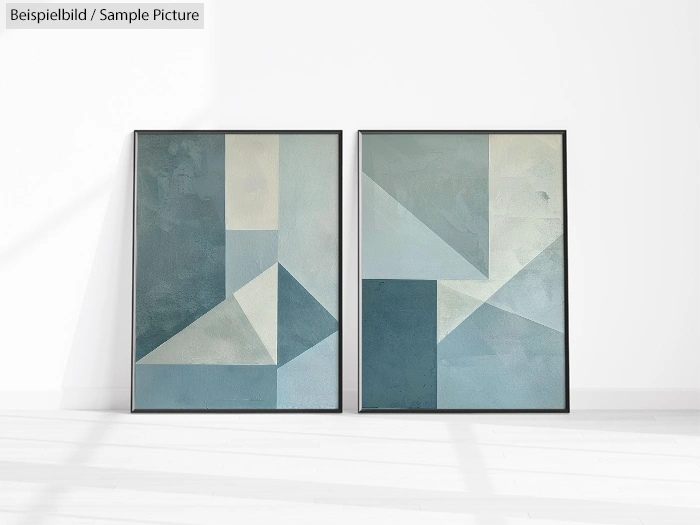 Two abstract geometric paintings with blue and gray tones, featuring triangular and rectangular shapes, framed and side by side.