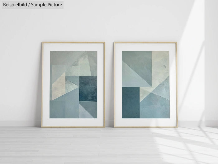 Two framed geometric abstract paintings with blue and gray tones, displayed on a white wall.