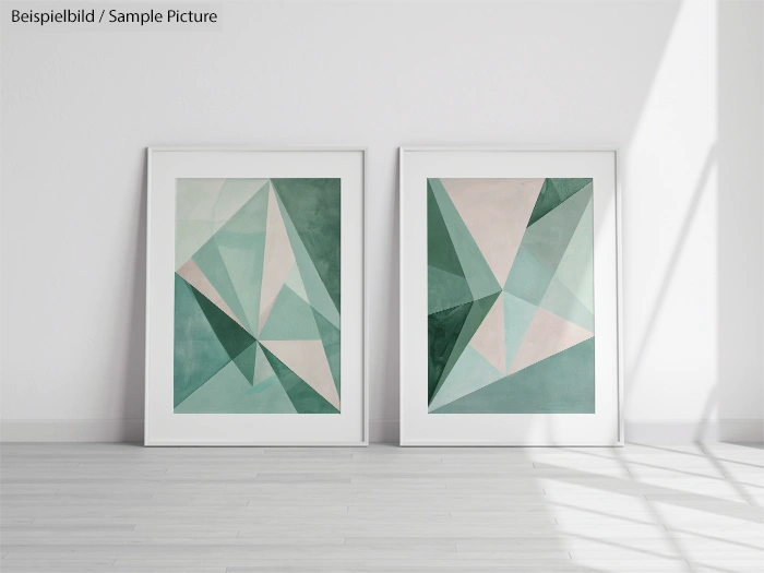 Two framed geometric abstract paintings with green and pink triangles in a white room with wooden floor.