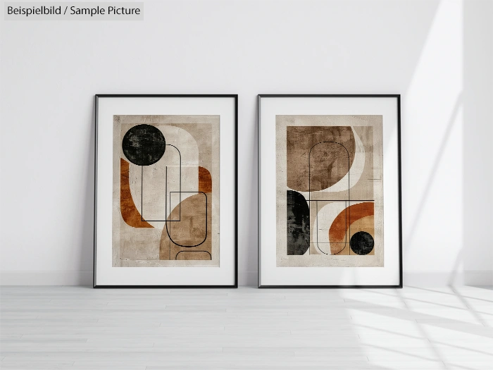 Two framed geometric abstract posters with earthy tones on a white wall.