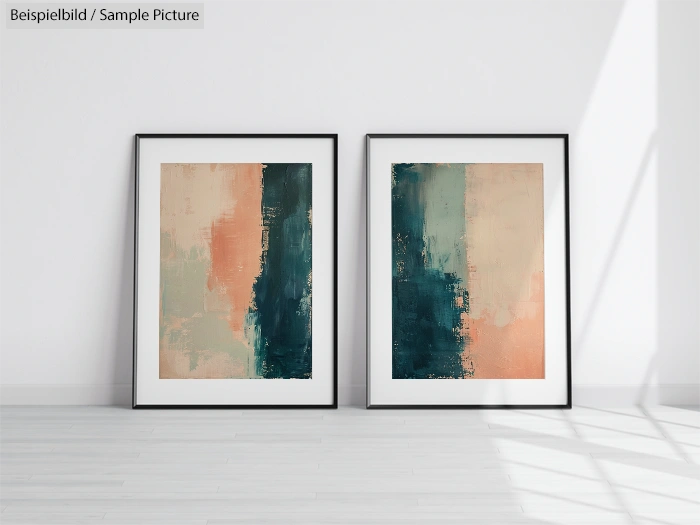 Two abstract paintings with blue and peach vertical brushstrokes, framed and displayed against a white wall.