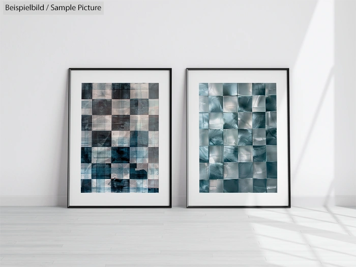 Two framed abstract paintings with blue and gray checkered patterns on a white wall.