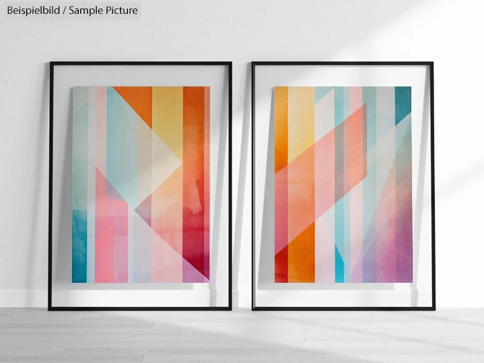 Pair of framed abstract geometric prints with colorful stripes on white wall background.