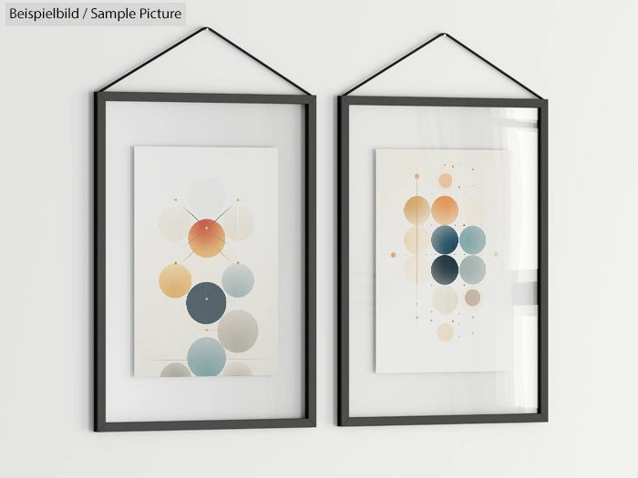 Two framed abstract art pieces with circular designs, featuring shades of blue, orange, and beige, hanging on a white wall.