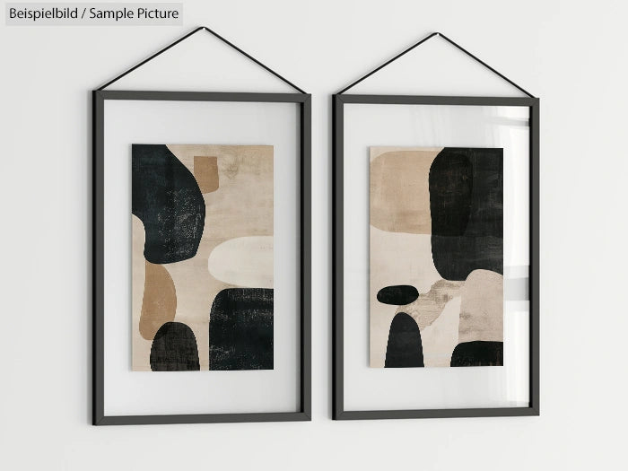 Two framed abstract paintings with geometric shapes in black, beige, and white tones, hanging on a white wall.