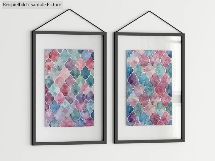 Two framed wall art pieces with colorful, geometric patterns in blue, pink, and green tones, hanging on a white wall.