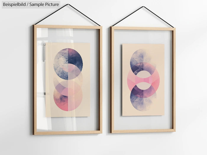 Two framed abstract prints with overlapping colored circles, one in pink and purple, the other in pink and blue.