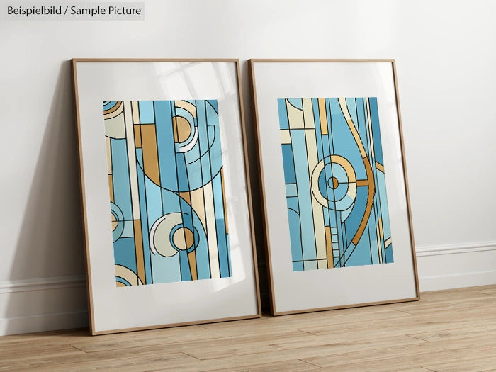 Two framed abstract art prints with blue and beige geometric designs leaning against a white wall.