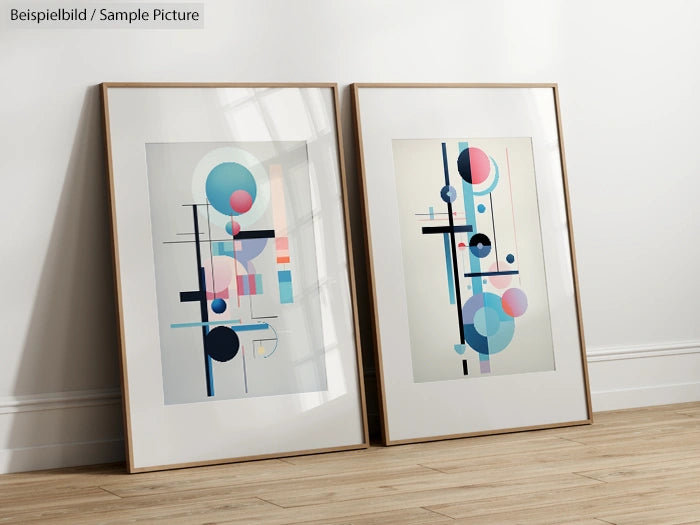 Two framed modern abstract paintings with geometric shapes leaning against a white wall.